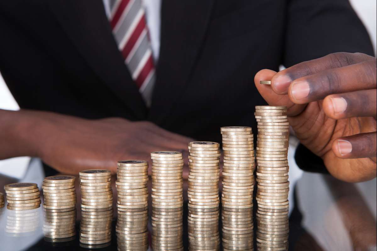 Businessman Stacking Coins (R) (S)