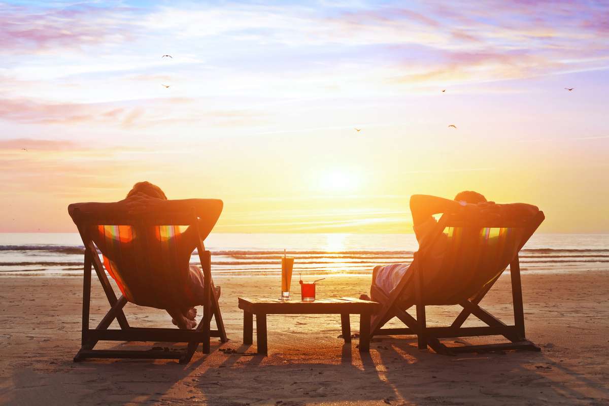 Couple enjoy sunset on the beach (R) (S)