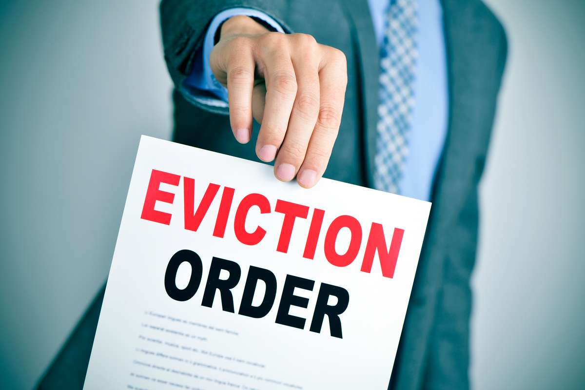 Man in suit with an eviction order (R) (S)