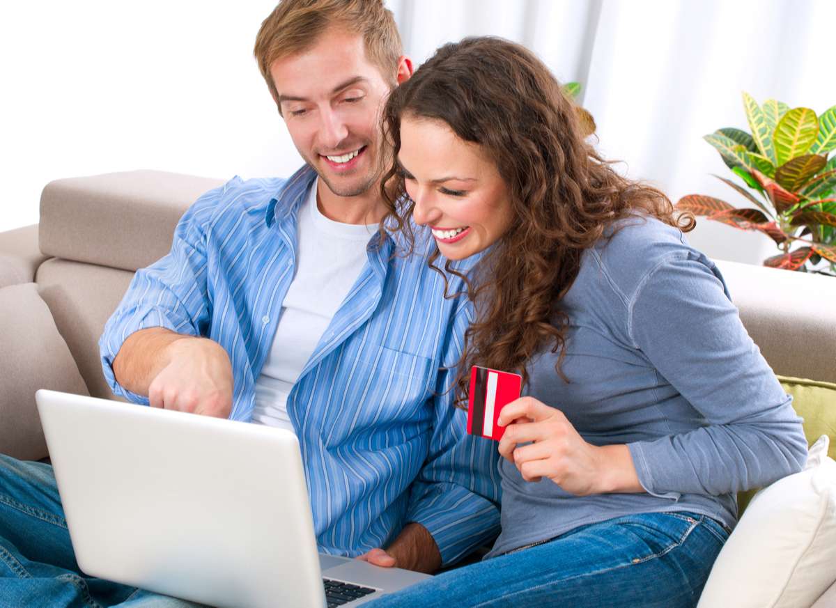 Young couple with Laptop and Credit Card buying online (R) (S)